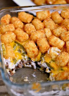 a casserole dish with tater tots in it and cheese on top