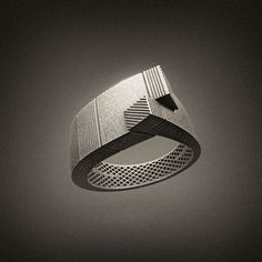 a black and white photo of a ring that is shaped to look like an object