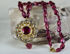 PRODUCT DETAILS TOTAL WEIGHT IS 257 CARAT NATURAL FINE QUALITY PINK TOURMALINE BEADS ALL NATURAL STONES LENGTH OF THE NECKLACE IS 16 INCHES DIMENSION OF THE PENDANT IS LENGTH-38MM / WIDTH-33MM / DEPTH-7MM DIMENSION OF THE PENDANT IS LENGTH-53MM / WIDTH-15MM / DEPTH-5MM SIZE OF THE BEADS ARE FROM 13MM TO 8MM MOST RARE UNIQUELY DESIGNED EXCLUSIVE ONE OF ITS KINDS BUY IT NOW NOTE - #You will receive the same product you see in picture. #DEAR ETSY BUYERS PLEASE FEEL FREE TO ASK QUESTIONS #WE WILL BE Spiritual Kundan Necklace With Gemstones For Celebration, Fusion Style Festival Jewelry With Gemstone Beads, Fusion Style Jewelry With Gemstone Beads For Festivals, Spiritual Gold Kundan Necklace With Gemstones, Gold Gemstone Beads And Cabochons, Gold Kundan Necklace With Gemstone For Spiritual Occasions, Gold Kundan Necklace With Gemstone For Spiritual Events, Gold Kundan Necklace With Gemstones For Spiritual Use, Gold Gemstone Round Beads, Gems And Cabochons