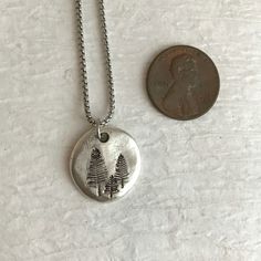 Please note: If you need more than one, multiple quantities are available upon checkout. Unique, simple, and affordable. A lovely, handcrafted pine tree charm perfect for a nature lover, avid hiker, or outdoor enthusiast. This small pewter hand stamped charm necklace is appropriate for everyday wear. It is appropriate for women and men. You may choose your length of sterling silver link chain or stainless steel box chain. The chains have a lobster clasp and are 1.5mm in thickness. Stainless stee Jewelry Rustic, Silver Link Chain, Hiking Gifts, Rustic Jewelry, Tree Necklace, Unisex Necklace, Silver Tree, Hand Stamped Jewelry, Tree Pendant