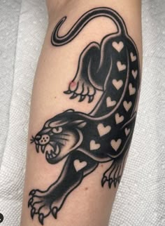 a black and white tattoo on the arm of a person with a heart shaped design