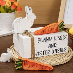 a wooden sign that says bunny kisses and easter wishes with carrots on the side