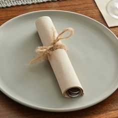 a roll of toilet paper wrapped in twine on a plate