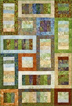 a green and brown quilt with lots of different colored squares on the top of it