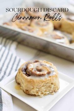 some cinnamon rolls on a white plate with the words sourdoughsicard cinnamon rolls