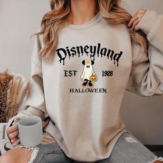 Magical Land Halloween Sweatshirt,Disneyland Sweatshirt,Disneyland Halloween Sweatshirt,Mickey And Minnie Sweatshirt,Spooky Season Sweater ### About Our Products - Our garments are crafted from a blend of 50% Cotton and 50% Polyester, ensuring both comfort and durability. - The medium-to-heavy weight fabric ensures long-lasting wear. - For your convenience, a tear-away label is included. - It provides a loose, comfortable fit that maintains true-to-size proportions. ### Find Your Fit Our sweatshirts are designed to fit true-to-size, offering a relaxed and stylish fit. Please refer to our detailed size chart with images to find your perfect size. ### Placing an Order 1. Review the product images and size charts for detailed information. 2. Select your preferred color. 3. Choose the correct Disney Sweater Outfit, Disneyland Sweatshirts, Disneyland Crewneck Sweatshirt, Winter Disney Cotton Sweatshirt, Fall Disney Outfits, Mickey Halloween Sweatshirt, Disney Long Sleeve Halloween Sweatshirt, Disneyland Sweatshirt, Disneyland 2024