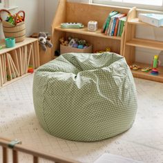 a child's room with a green bean bag chair