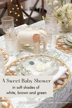 a baby shower in soft shades of white, brown and green with an elephant figurine