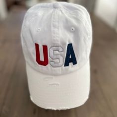 a white usa hat sitting on top of a wooden floor