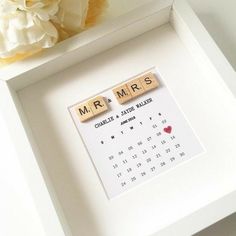 a scrabble tile calendar with the word mr and mrs spelled in wooden letters