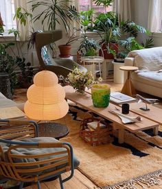 a living room filled with furniture and lots of plants