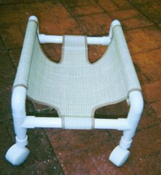 a white chair sitting on top of a tile floor next to a red tiled floor