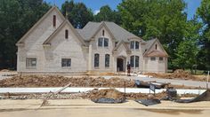 a house is being built in the middle of a construction area with dirt on the ground