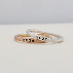 This beautifully crafted Class Signet Ring and Birthstone Set is the perfect graduation gift. Each set includes a classic signet ring and birthstone ring, handmade with precision and care. Show off your school pride and celebrate your achievements with this elegant and timeless accessory. Available in 14k gold filled and fine silver. Elegant Promise Rings With Hand Stamping, Elegant Hand Stamped Promise Rings, Hand Stamped Stackable Rings For Anniversary, Classic Hand Stamped Rings For Anniversary, Classic Hand Stamped Anniversary Rings, Minimalist Hand Stamped Engraved Ring For Anniversary, Stackable Signet Ring With Round Band For Anniversary, Anniversary Stackable Signet Ring With Round Band, Classic Engraved Stackable Ring For Anniversary