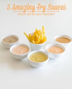 five small white bowls filled with fries and dipping sauces