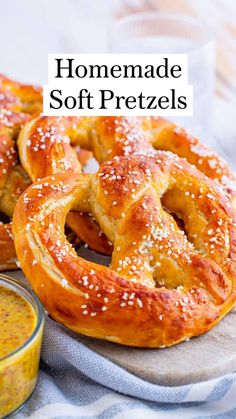 homemade soft pretzels on a cutting board with dipping sauce