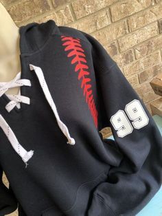 a baseball hoodie with the number 98 on it sitting on top of a bench