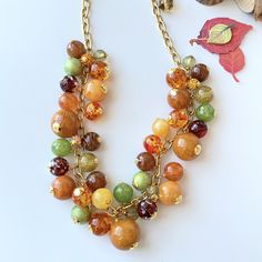 Complete that fall outfit for a picture-perfect look with this longer version of our bauble charm necklace.  Bursting with chunky charms in warm autumn tones of honey, golden, moss, chestnut, and sunshine this statement necklace is ready for sweater weather and to have you look like fall perfection on that hayride! Rhinestone pave bring the bling and sophistication to these pieces. Make an entrance at Thanksgiving with these autumn accessories. This necklace measures 26-inches with 3-inch extender. Make it a set with the Hayride Bracelet. Handmade Multicolor Jewelry For Fall, Brown Jewelry For Fall Gifts, Brown Jewelry Gift For Fall, Brown Jewelry For Fall Season Gift, Autumn Accessories, Autumn Tones, Chunky Statement Necklace, Fall Accessories, Warm Autumn