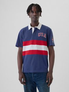 Soft cotton rugby polo shirt.  Polo collar, button placket.  Short sleeves.  Team USA graphics at chest and sleeve.  * Fit: Classic.  A straight & easy fit.  Hits at the hip.  Models are 6′1″–6′2″ 185 cm–188 cm) with a 31″ 79 cm) waist & 32–33″ 81 cm–84 cm) inseam & are wearing Gap Rugby Polo, Team Usa, Polo Collar, Button Placket, Rugby, White Stripe, Polo Ralph Lauren, Polo Shirt, Short Sleeves