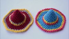 two crocheted hats sitting next to each other