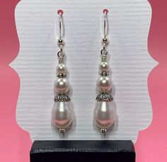 You are looking at an elegant pair of earrings made with round and teardrop shaped white Swarovski pearls surrounded by sterling silver bead caps, sterling silver spacer beads and small round sterling silver beads. The earrings measure approximately 2 inches from the top of the sterling silver earwire. Click here to see other earrings in my shop: https://www.etsy.com/shop/JewelryDesignsByRita?section_id=14765680 I have been designing and making jewelry since 2010. I use only the highest quality Elegant White Earrings With Silver Beads, Elegant White Beaded Sterling Silver Earrings, Elegant White Beaded Teardrop Earrings, Classic White Sterling Silver Teardrop Earrings, Classic White Teardrop Sterling Silver Earrings, Elegant Sterling Silver Beaded Earrings For Wedding, Elegant Nickel-free Drop Beaded Earrings, Elegant Silver Beaded Hypoallergenic Earrings, White Teardrop Pearl Drop Beaded Earrings