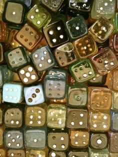 many different colored dices with holes in them