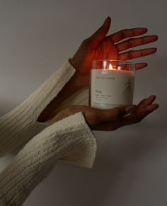 a person holding a candle in their hands