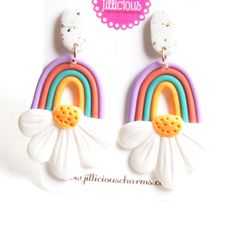 These earrings feature a pair of handmade rainbow flower charms made from polymer clay. The entire earrings length is 6 cm. Cute Multicolor Polymer Clay Earrings, Playful Rainbow Polymer Clay Jewelry, Rainbow Polymer Clay Jewelry For Gifts, Playful Handmade Multicolor Flower Earrings, Playful Multicolor Handmade Flower Earrings, Dangle Earrings With Flower Charm In Polymer Clay, Whimsical Multicolor Polymer Clay Earrings, Whimsical Flower-shaped Polymer Clay Earrings, White Hand Painted Polymer Clay Flower Earrings