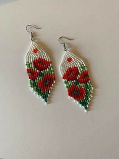 the beaded earrings are decorated with red flowers