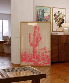 a room filled with furniture and pictures on the wall next to a wooden table in front of a window