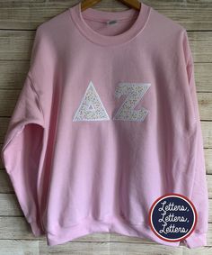 a pink sweatshirt with the letter z on it