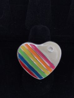 This is a necklace that emanates joy! I love the 1980s, hearts, and rainbows...so I'm on the lookout for pieces that combine all three of those elements and this was a rare find! There are very few of the authentic 80s rainbow jewelry pieces left these days. This ring has an adjustable band, so should fit most sizes! Please inspect the photographs thoroughly as this is a vintage item, which means often times the item is not perfect due to usage, and I do not offer refunds based on flaws that are Rainbow Retro Jewelry For Gift, Multicolor Heart-shaped Ring For Gift, Multicolor Retro Jewelry For Gift, Retro Rainbow Jewelry Gift, Retro Rainbow Colored Jewelry Gift, Retro Rainbow Jewelry For Gifts, Rainbow Jewelry For Valentine's Day Gift, Valentine's Day Multicolor Ring Jewelry, Rainbow Heart Pendant Jewelry Gift