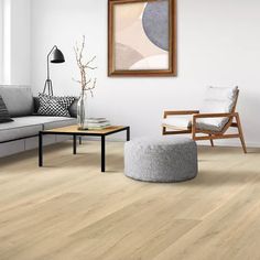 a living room with white walls and wood flooring on the floors is pictured in this image