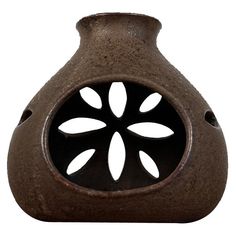 a brown vase with holes in the center on a white background is seen from the side