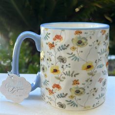 a blue and white coffee mug sitting on top of a table