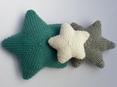 three knitted starfish pillows sitting next to each other