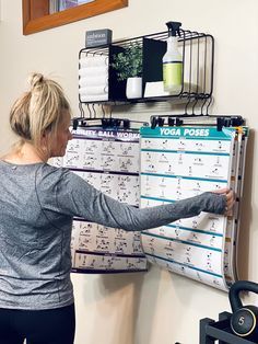 a woman standing in front of a wall calendar