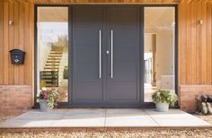 the front entrance to a house with two large doors