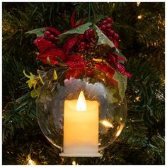 a lighted candle in a glass ball ornament