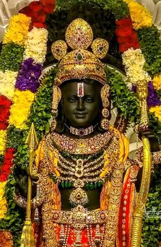 the statue is surrounded by flowers and garlands