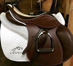 a brown and white horse saddle with the word country on it's front side