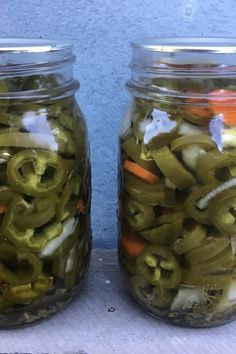 two mason jars filled with pickles and carrots