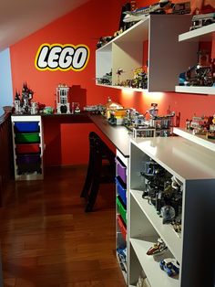 a room filled with lots of toys and legos on the wall next to a desk