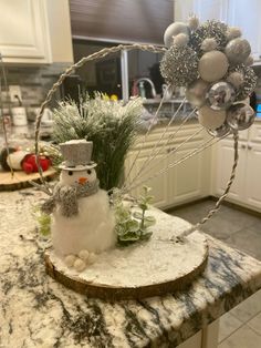 a snowman decoration on top of a kitchen counter