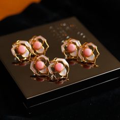 Experience the allure of royalty with our Pink Queen Conch Pearl Rose Earrings. Adorned with exquisite pink pearls sourced from the majestic Queen Conch shell, these earrings embody elegance and sophistication. The seamless blend of the lustrous pink pearls with delicate rose-shaped white Mother of Pearl petals creates a stunning visual harmony. Crafted with 925 sterling silver, these earrings are a testament to impeccable craftsmanship and enduring beauty. Embrace the regal charm of our Pink Qu Luxury Pink Round Earrings, Elegant Pink Gold Flower Jewelry, Blush Luxury Formal Jewelry, Elegant Pink Flower-shaped Jewelry, Rose Gold Feminine Pearl Earrings For Formal Occasions, Feminine Rose Gold Pearl Earrings For Formal Occasions, Luxury Rose Gold Pearl Earrings For Wedding, Elegant Coral Jewelry With Pearl Drop, Feminine Pink Pearl Drop Jewelry