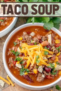 two white bowls filled with taco soup on top of a wooden table