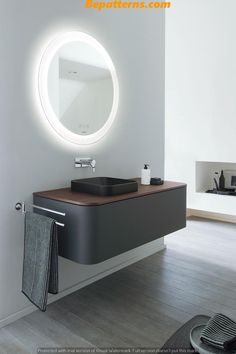 a bathroom with a sink, mirror and towel rack in it's center area