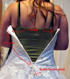 the back of a woman's wedding dress, with instructions for how to attach it