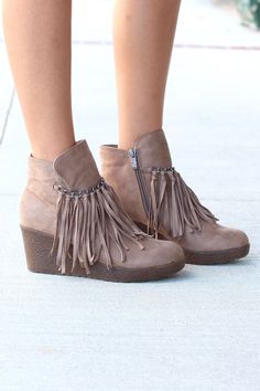 Be cute, stylish, and flirty in these low wedge ankle booties featuring a chain and fringe front. Taupe in color. - Heel height: approx. 3" - Wedge style heel. - Non-slip sole. - Lightly padded footbed. - Soft suede, man-made upper. - Inner zipper for easy on/off. - Fits true to size. - Whole sizes only. Comfortable Wedges Sandals, Summer Shoes Wedges, Delicate Gold Ring, Fringe Booties, Wedge Bootie, Wedges Style, Low Wedges, Boot Cuffs, Shoe Boutique