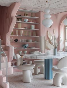 a dining room with pink walls and white chairs in the center, along with shelves filled with vases and bowls